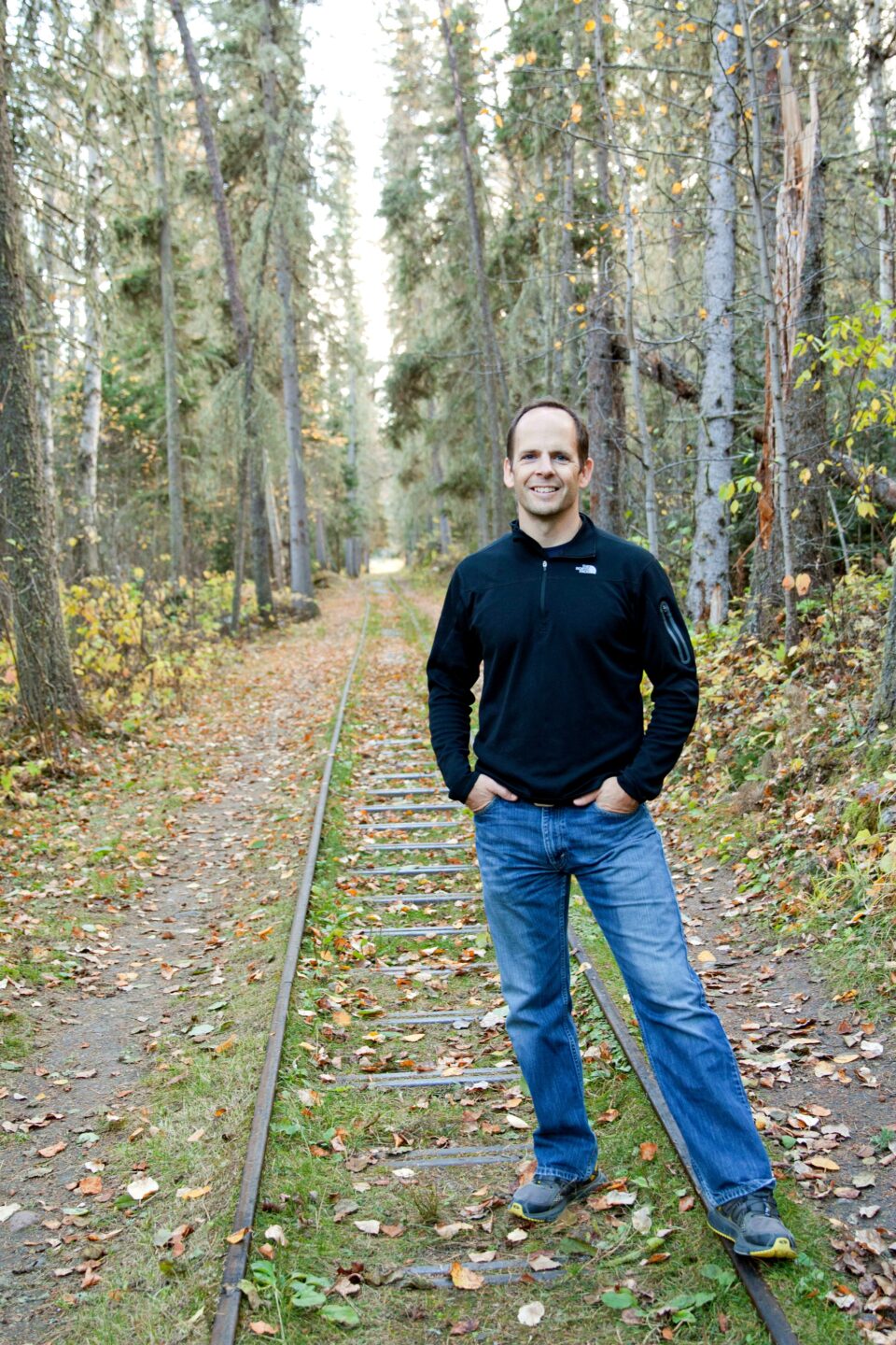 Kregg at U of S Kregg a physiotherapist standing in a forest smiling